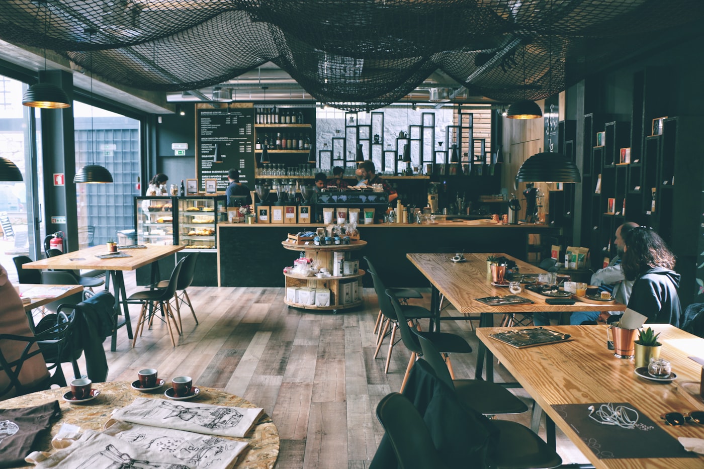 Industrial-minimalist café interior with concrete tones and warm pendant lighting (placeholder — awaiting client photos)