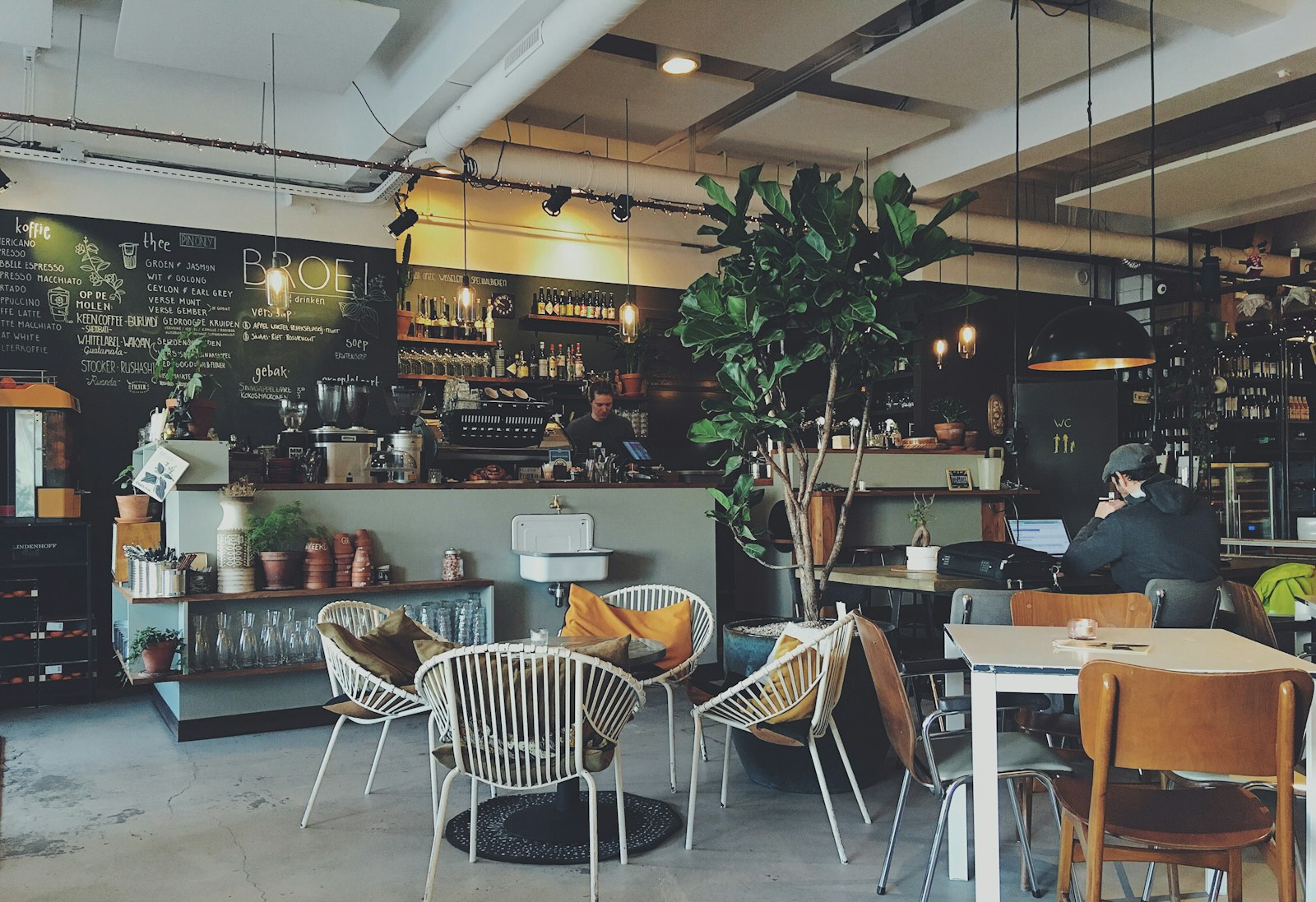 Warm-lit café interior with concrete and wood tones (placeholder — awaiting client photos)