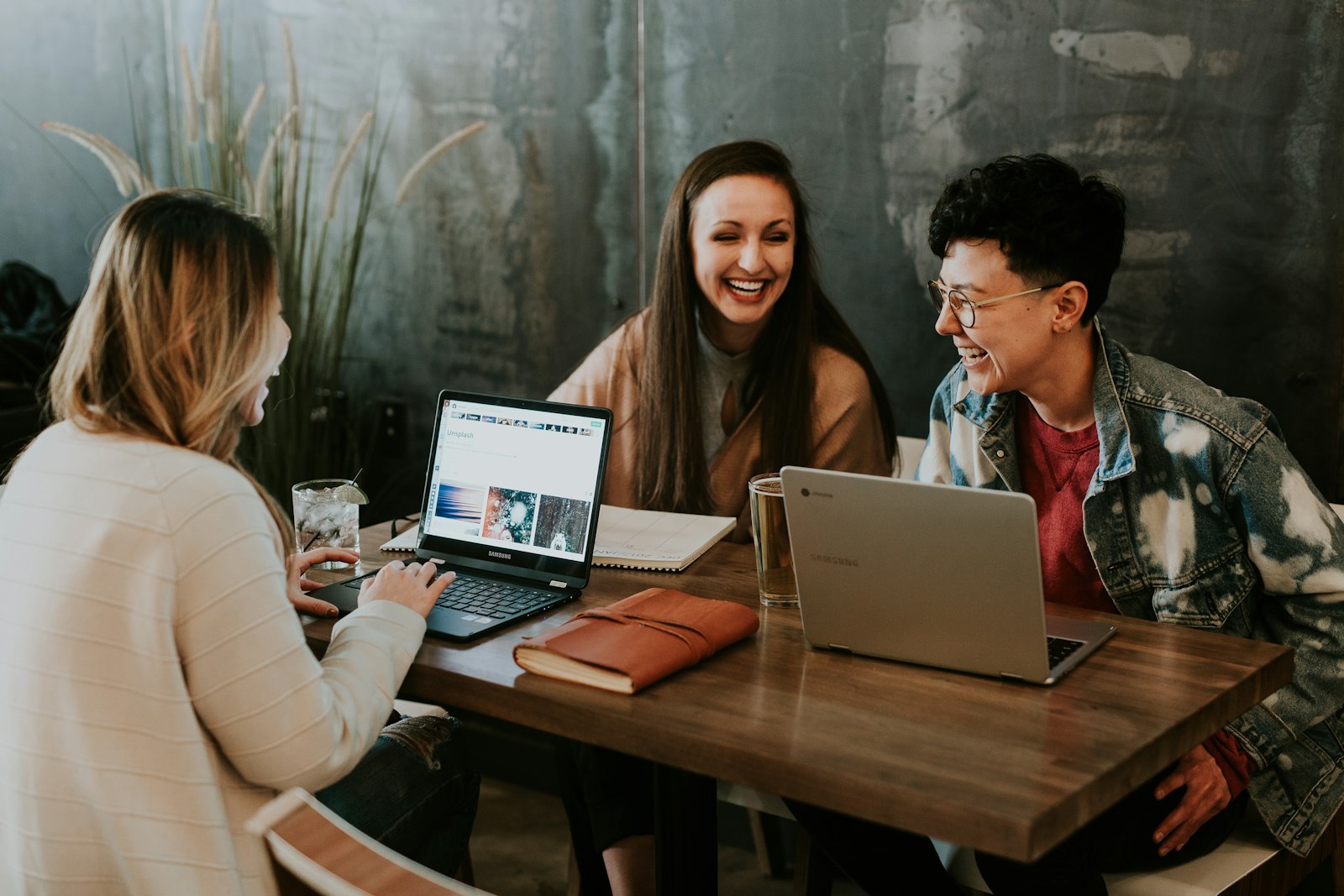 Guests working on laptops at a café table (placeholder — awaiting client photos)